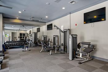 A well-equipped gym with a variety of machines and weights. at 46 Penn Apartment Homes, Kansas City, 64111